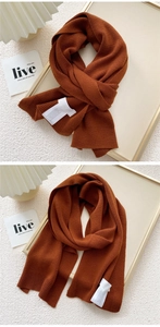 Detailed texture of caramel knitted scarf with thick rib-knit pattern and soft fabric