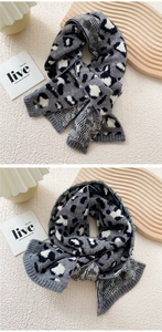Detailed view of the leopard print knit scarf with fine texture and ribbed edge detail