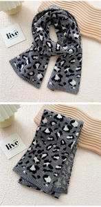 Close-up of gray leopard print knit scarf with thick ribbed edges and soft texture