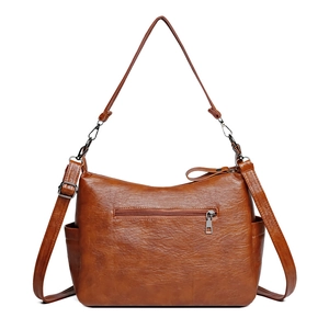 Versatile vintage brown leather handbag with convertible straps shown from back view