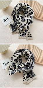 Close-up of leopard print knitted scarf with ribbed edges and soft texture on white background