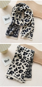 Detailed macro view of soft leopard print knitted scarf texture and ribbed edge craftsmanship