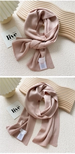 Detail of soft lotus pink knitted scarf showing fine texture and ribbed edge finish