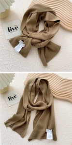Close-up of khaki knit scarf showing fine texture, ribbed edges and soft fabric details