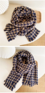 Detail of blue and brown houndstooth scarf with soft fringe and knitted texture