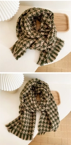 Detail of green and beige houndstooth knit scarf with soft fringe texture for autumn winter