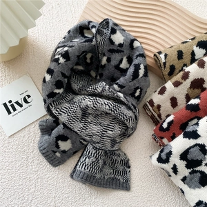 Winter knitted leopard print scarves collection in various colors on a decorative tray