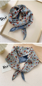 Close-up of a double-layered floral silk neck scarf with blue and red patterns