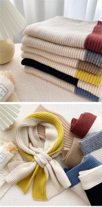 Detail of multi-colored ribbed knit scarf with warm wool texture and crossed styling
