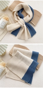 Macro detail of ribbed knit texture on cream and navy blue winter scarf
