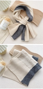Detail of soft knit texture on a bicolor beige and grey cross scarf for winter style