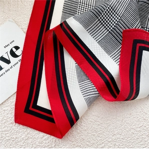 Detail of red and black houndstooth pattern on a luxury square silk scarf for women