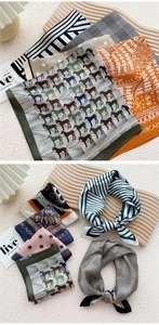 Close-up of assorted silk square scarves featuring houndstooth and geometric prints