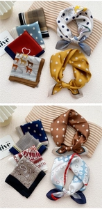 Detailed view of various silk-like square scarves featuring polka dots and horse patterns
