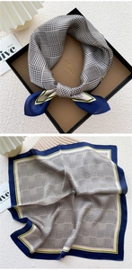Detailed close-up of mulberry silk scarf with houndstooth pattern and blue borders