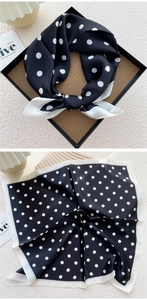 Detailed view of mulberry silk scarf with polka dot pattern in a premium gift box