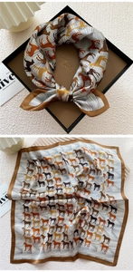 Detailed view of silk square scarf with horse pattern and premium black gift packaging box