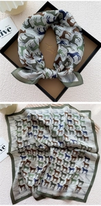 Detail of silk scarf showing vintage horse print and refined dark green hemmed edges