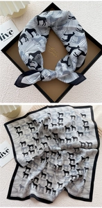 Detail of silk square scarf featuring black horse silhouettes and geometric lines