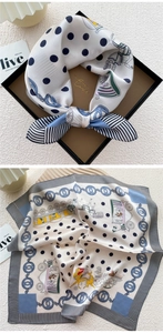 Close-up of silk scarf showing vintage horse carriage and navy polka dot patterns