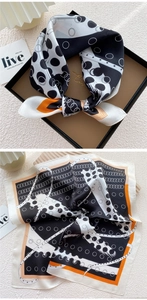 Detail of silk square scarf featuring black and white polka dots with orange border