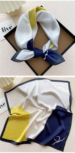 Detail of a tricolor silk square scarf with heart patterns in an elegant gift box