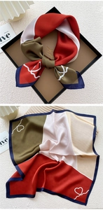Detail of silk square scarf featuring elegant satin luster and retro color-block patchwork