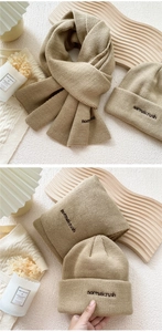 Detail of warm beige knitted hat and scarf set with distinct vertical ribbed texture