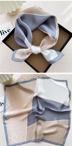 Detail of silk square scarf with geometric blocks and heart patterns in a gift box
