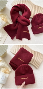 Detailed knit texture and yellow normalcrush embroidery on the dark red scarf and beanie