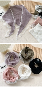 Close-up of cotton linen triangle scarves featuring crochet lace edges and mini pom-poms