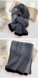 Macro detail of the black and white wave pattern knit scarf with wide ribbed edges