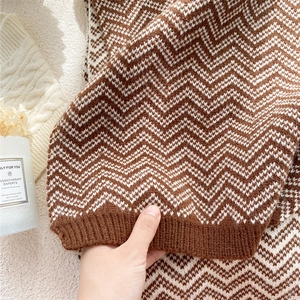 Brown and white wavy knit scarf featuring cozy ribbed edges and premium warm texture