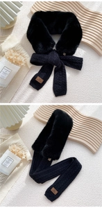 Detail of black faux fur scarf featuring knit splice and brown leather brand label