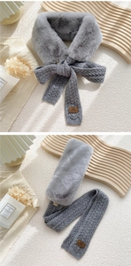 Detail of grey faux fur scarf with chunky knit pattern and premium leather logo tag