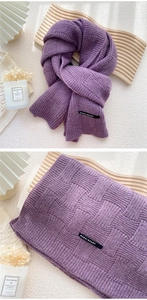 Gros plan d'une écharpe en maille violette avec motif à damier et étiquette de marque
