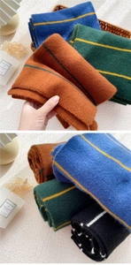 Detail showing the thick knitted texture and colorful striped patterns of winter scarves