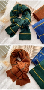 Close-up of soft knitted striped scarf texture in dark green and caramel colors