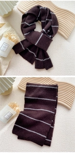 Detailed texture of thick ribbed knit dark coffee scarf with light grey stripes