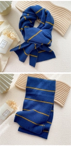 Close-up of blue knitted scarf with yellow stripes and soft wool texture detail