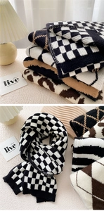 Macro shot of thick knitted scarves featuring checkerboard and wave patterns for winter