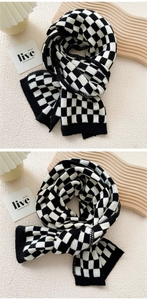 Detailed close-up showing the knit texture of black and white checkered scarf