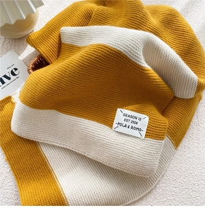 Close-up of ginger yellow and white striped knit texture and SEASON 12 brand label