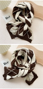 Detailed macro shot of vintage brown and cream argyle pattern on a thick knit scarf