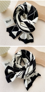 Detail shot of the thick knitted winter scarf featuring a classic black and white argyle pattern
