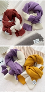 Detailed knit texture of a thick striped scarf featuring a stylish brand label