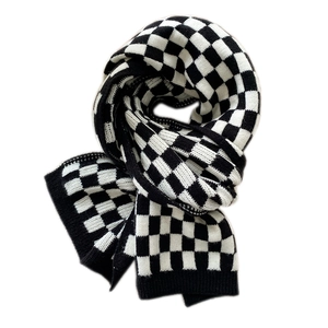 Classic black and white checkered knit scarf with thick warm texture for winter style