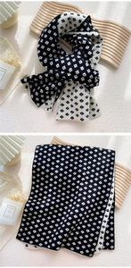 Macro detail of a double-sided black and white plaid knitted scarf with a soft texture