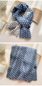Close-up of blue and white double-sided jacquard knit scarf with geometric lattice pattern
