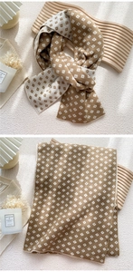 Close-up of double-sided knit scarf with khaki diamond pattern and soft plush texture